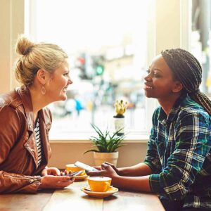 Two women talking in a restaurant.