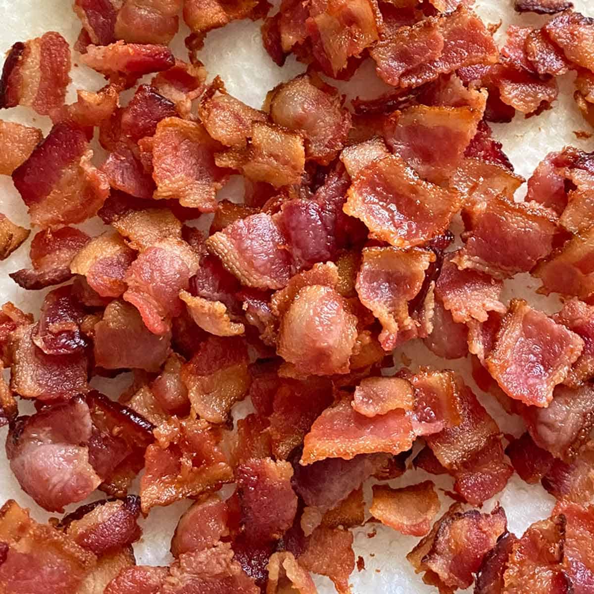 Freshly cooked bacon bits draining on paper towels.