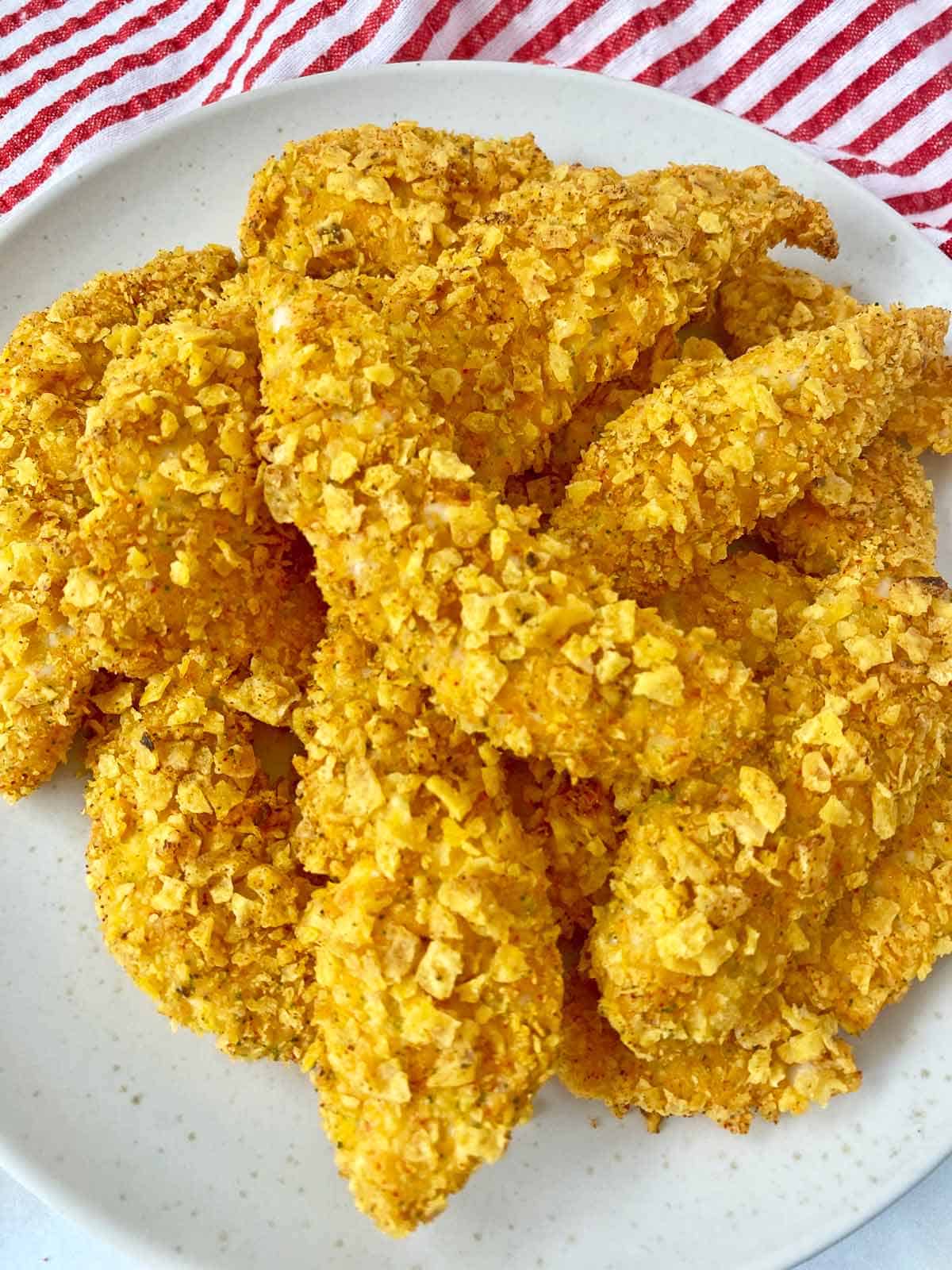 Cool ranch Doritos chicken piled on a white serving plate. 