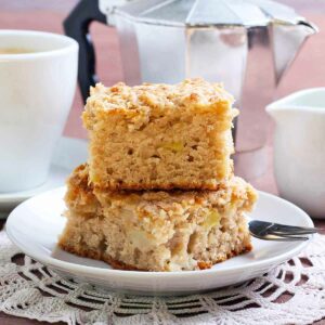 2 slices of cinnamon sugar apple cake on a white dish.