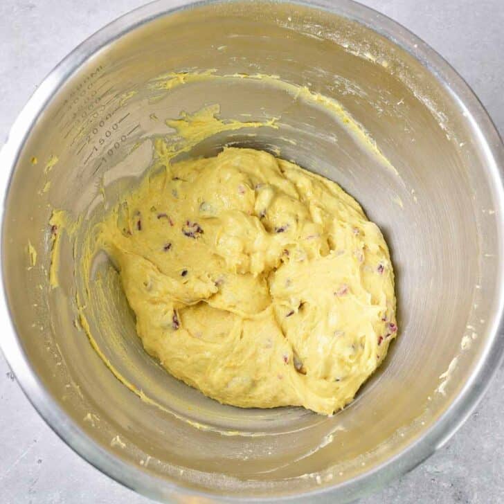 Cookie dough in a stainless mixing bowl.