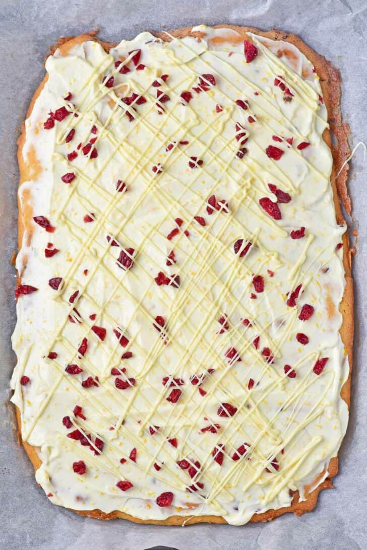 Uncut cranberry white chocolate bars topped with dried cranberries.