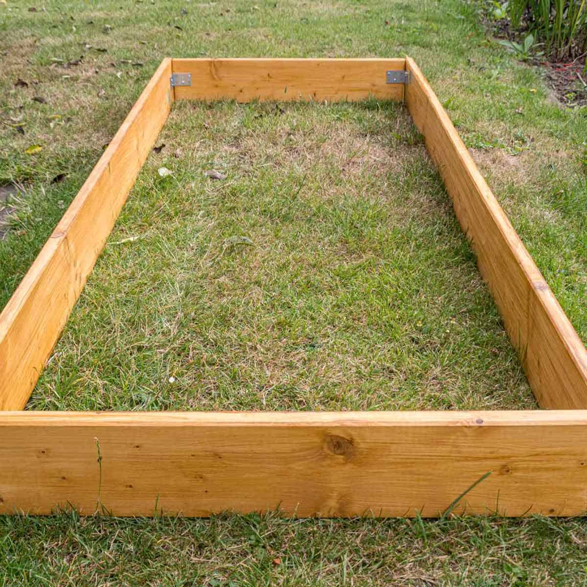 A raised garden bed that is not planted and is going fallow.