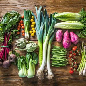 Fresh garden vegetables including leeks, artichokes, cherry tomatoes, Bok choy and beets.