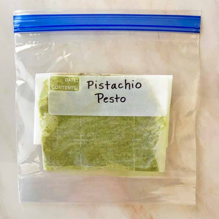 Pistachio Pesto Sauce inside a parchment paper lined freezer bag.