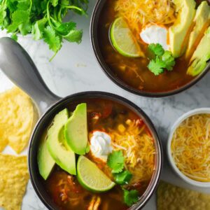 Two bowls of thrifty chili ready for serving.