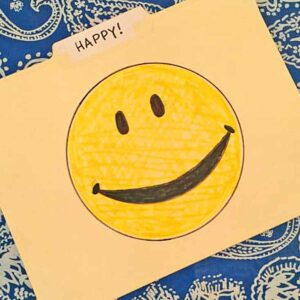 A file folder with a happy face on it.