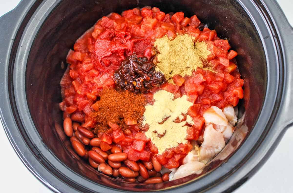 All the ingredients for southwest chicken chili in the slow cooker insert.