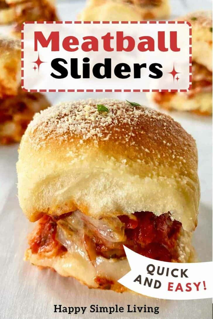 A meatball slider with melted cheese and sprinkled with Parmesan cheese.