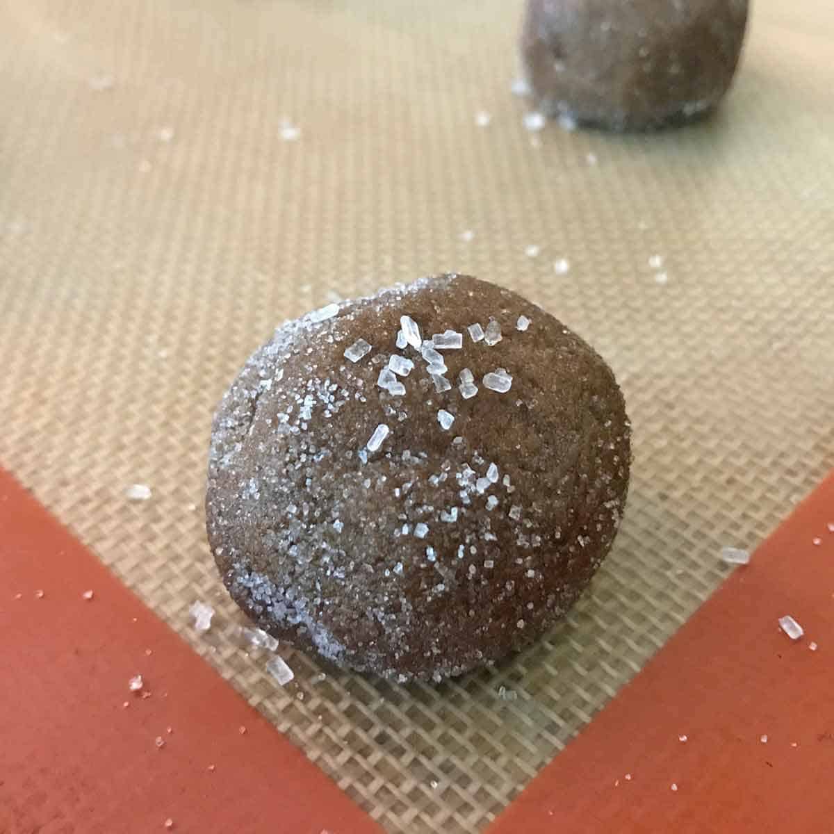 Close up of cookie dough ball topped with crystal sugar.