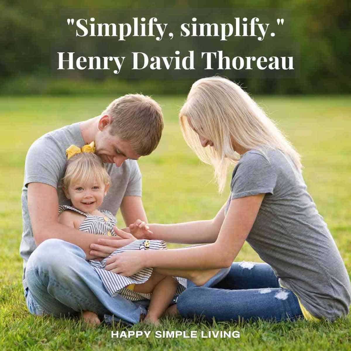 A family sitting outside on green grass.