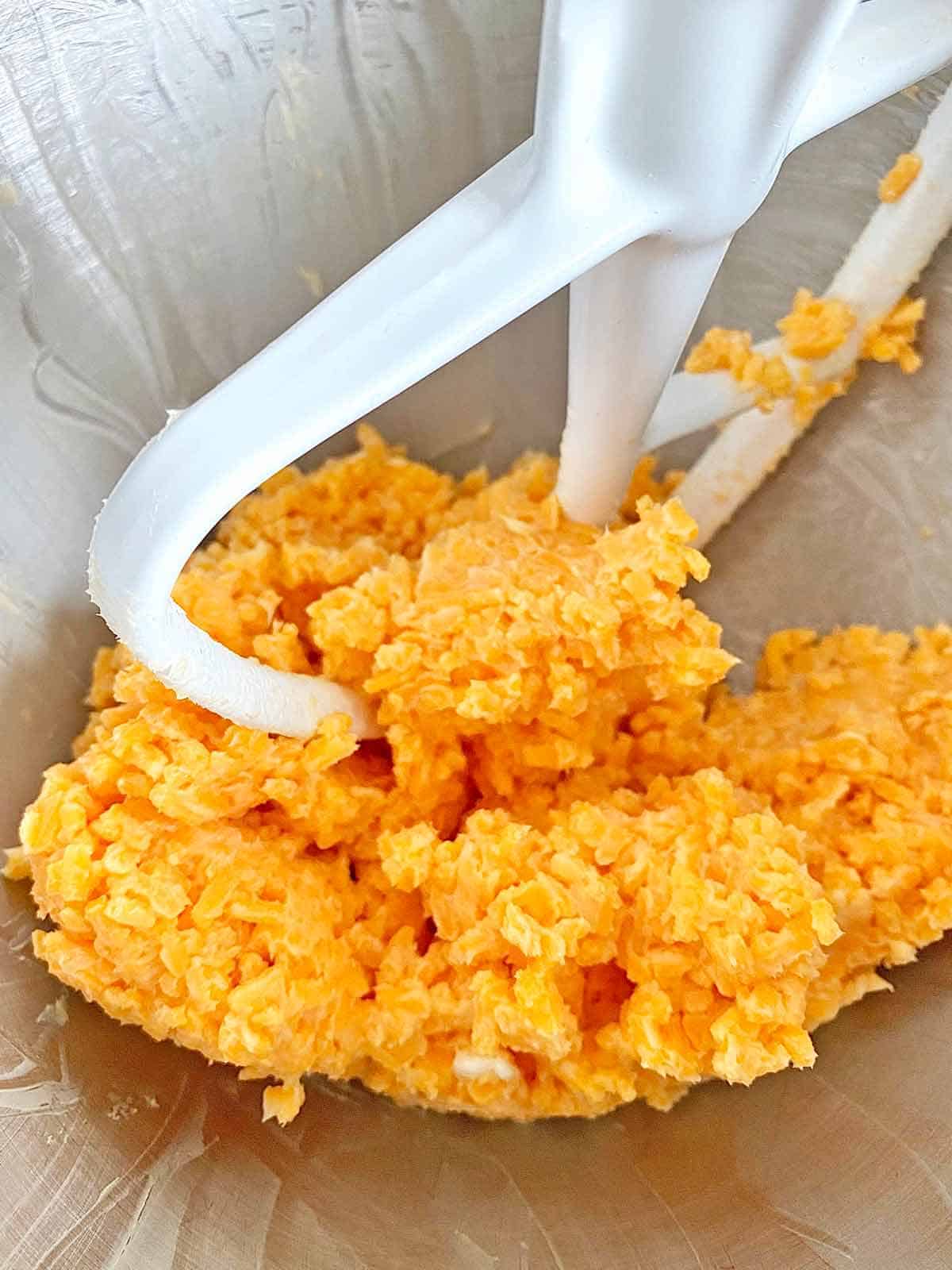 Mixing dough for DIY cheese crackers in a stand mixer.