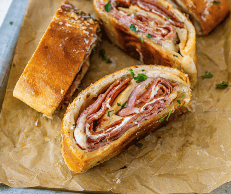 Three slices of stromboli on a cutting board.